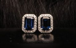A special pair of emerald-cut blue sapphire earrings of nearly 2 carats, encrusted with diamonds in 18ct white gold from Hatton Garden
