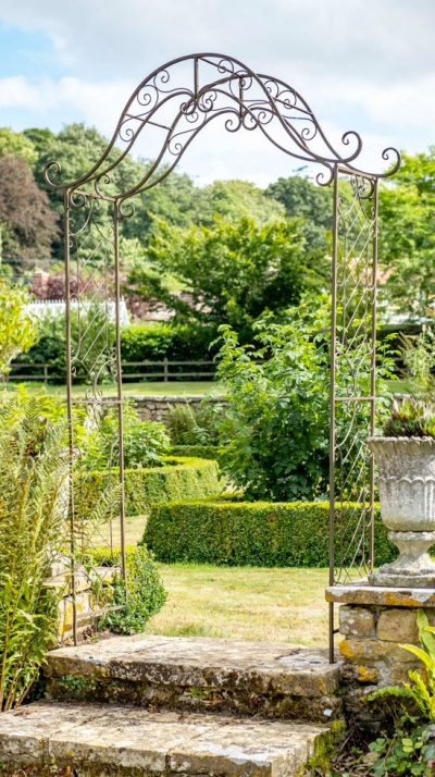 Elegant French-inspired Fleur de Lys Arch with Lattice by the expert garden designers at Ascalon Design of Hereford