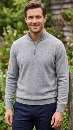 Man in Massoti extrafine lambswool half-zip sweater in silver grey, elegant garden portrait – timeless Italian men’s knitwear