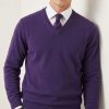 Model wearing the Massoti extra-fine Italian lambswool V-neck sweater in rich navy blue, layered over a white shirt and silk tie — elegant Italian knitwear for the modern gentleman.