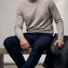 Massoti roll-neck jumper in natural beige extrafine Australian Merino wool, modelled at CountryClubuk.