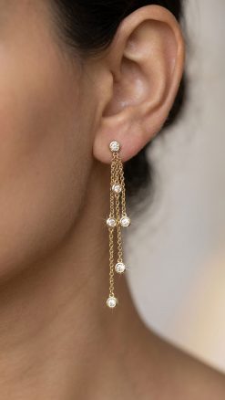 Effy New York 14ct gold diamond chain drop earrings with bezel-set natural diamonds worn on ear
