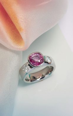 Natural Ceylon pink sapphire 2.65 carats, cushion cut; diamonds 0.40 carats, F/VS, round brilliant cut. Platinum setting. Craftsman made in Hatton Garden. CountryClubuk Members' best price guarantee.