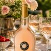 Bottle of Château Miraval Rosé 2025 Provence rosé wine served chilled on a summer garden table with crystal glasses and flowers.