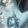 large cushion cut Ceylon aquamarine pendant surrounded by diamond halo in platinum