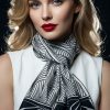 Fox & Chave Deco New York crêpe de chine silk scarf modeled on a woman, featuring bold black geometric scalloped fans and fronds on white background