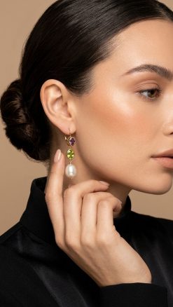 Woman wearing 14K yellow gold amethyst peridot pearl drop earrings