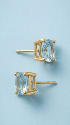 8ct gold 7mm cushion cut aquamarine stud earrings on blue background showing clarity and setting