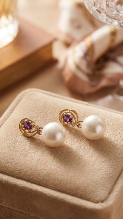 Aurelia pearl earrings in 14ct gold with amethyst gemstones displayed in a presentation box