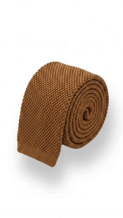 Close-up of textured pure silk burnt orange knitted tie showing square-end detail