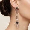 Woman wearing Effy Art Deco black and white diamond drop earrings
