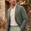 Magee 1866 Westport Blazer in textured pale sage green pure cotton basket weave worn with polo shirt and chinos at CountryClubuk