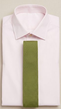 Olive green knitted pure silk tie displayed on light pink shirt