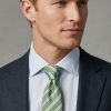 Sage green striped pure silk tie worn with light blue shirt and navy suit – Savile Row inspired striped tie for Spring Summer 2026