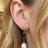 Seraphine pearl earrings in 14ct gold with peridot, garnet and pearl worn on model