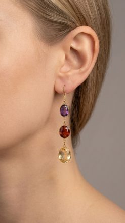 Elegant 14K yellow gold amethyst, garnet and citrine triple drop earrings worn by a model, showcasing graceful movement and vibrant gemstone colours