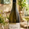 Domaine Merlin Jeanraude 2023 Condrieu with wine glass and summer dining setting outdoors in Provence-style landscape by CountryClubuk
