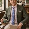 The Viago olive linen jacket by Gurteen styled for relaxed summer tailoring and smart-casual occasions