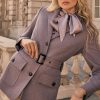 Model wearing the Really Wild Meryl Safari Jacket in sand herringbone with belted waist and safari pocket detailing.