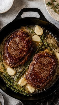 Seared Certified Irish Black Angus fillet steaks cooked in butter with garlic and thyme