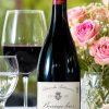 Bottle of Domaine Dupeuble Château des Pertonnières Beaujolais 2023 on a table with wine glasses and pink roses
