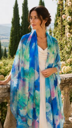 Woman wearing the Rose Garden pure silk chiffon stole in blue floral watercolour design with ivory silk dress.